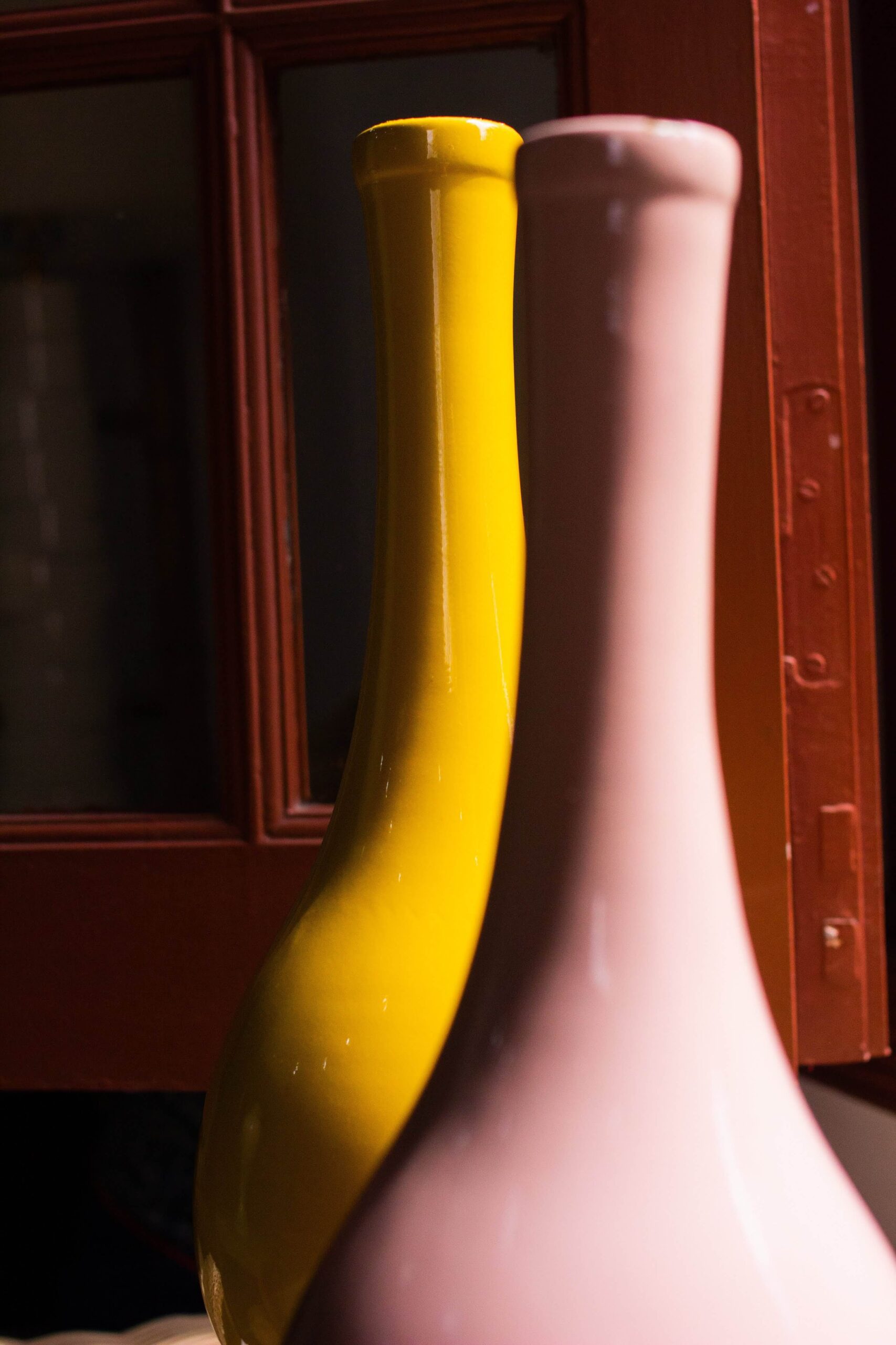 neck of one pink and one yellow lacquer vase