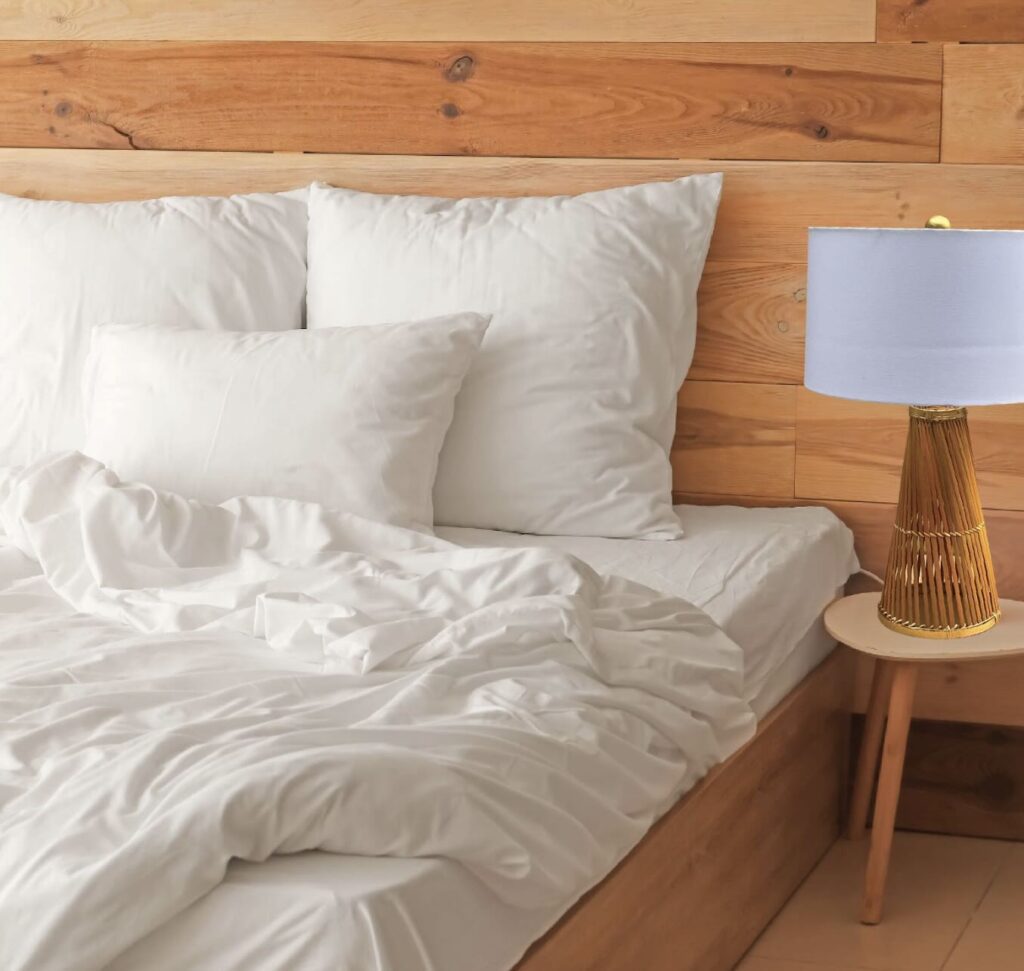 A bed room with a bamboo lamp